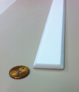 Batten strip, or turn around and use as corner molding, for covering seams.  Adhere to wall with silicone.