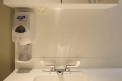 Corian Cabitnets, Vanity Top, and Integrated Sink in Off White Solid Surface in a Healthcare Setting