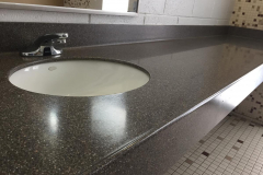 University of California San Diego Gym Restroom Countertop in Solid Surface with Undermount Porcelain Sink, Coved Backsplash, and  3" Front Apron