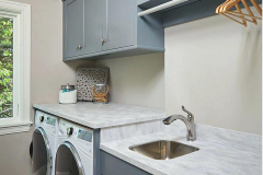 Laundry Room with Solid Surface Countertops and Stainless Sink