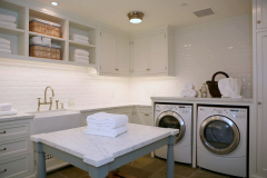 Laundry room with solid surface island and countertops.