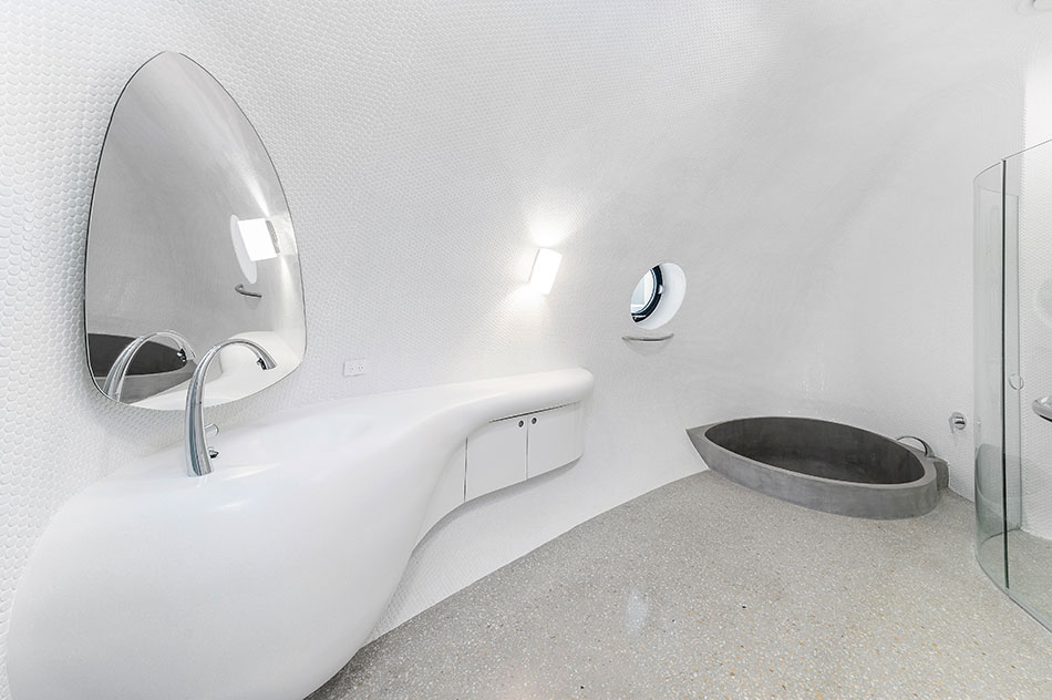 Seamless, curved vanity top in Antarctica Corian® designed by Raunik Design Group Courtesy of Rezolution Photography