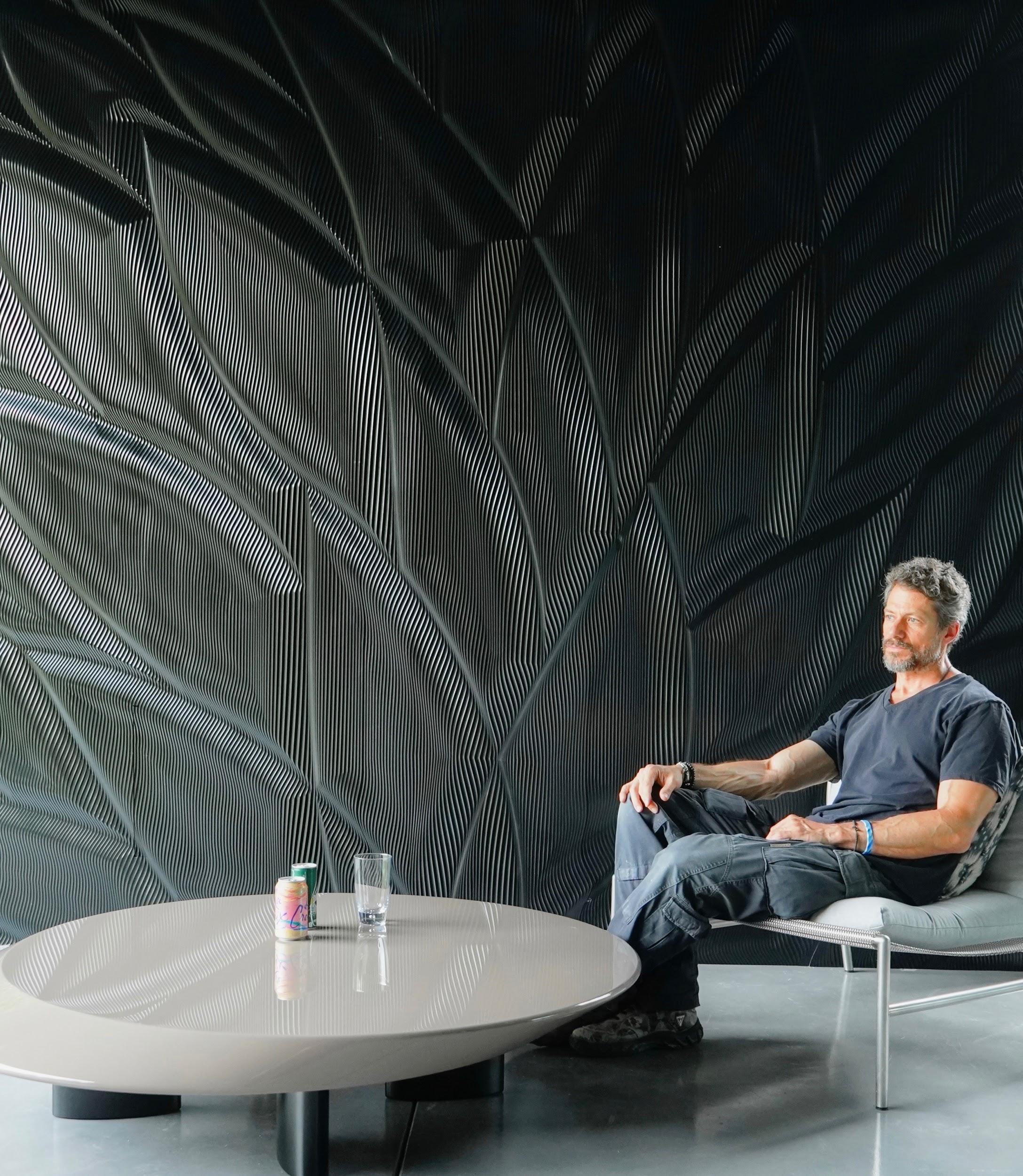 Mario Romano Enjoys One Of His Sculptured Walls Made Of Corian Solid Surface Solidsurface Com Blog
