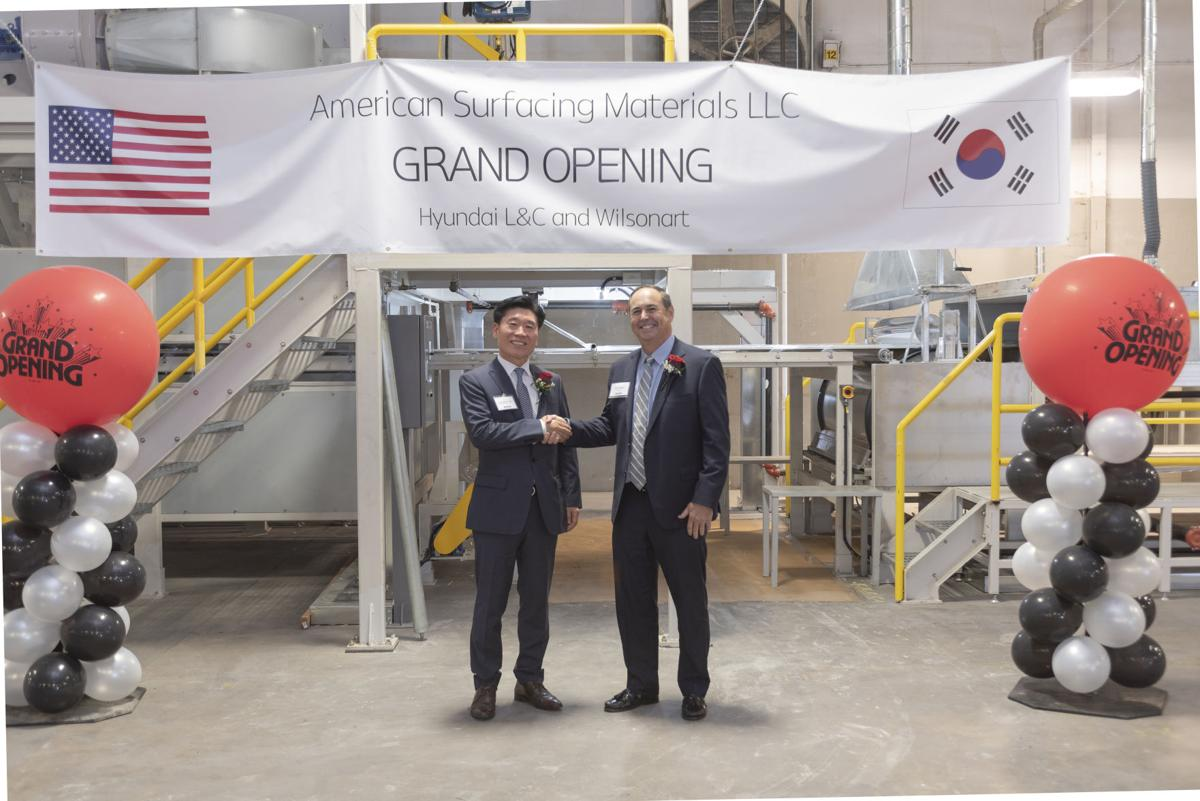 Jung Seok Yoo, left, chief executive officer of Hyundai L&C USA, shakes hands with Wilsonart chief executive officer Tim O’Brien at the new American Surfacing Materials manufacturing plant in Temple.